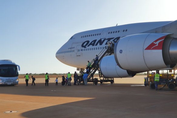 Australians arrive at RAAF Base Learmonth in WA on a Qantas flight from China on February 4 last year.