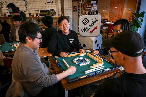 Michael Zhao, centre, the organiser of a weekly Japanese Mahjong night at Melbourne’s Marche Board Game Cafe.