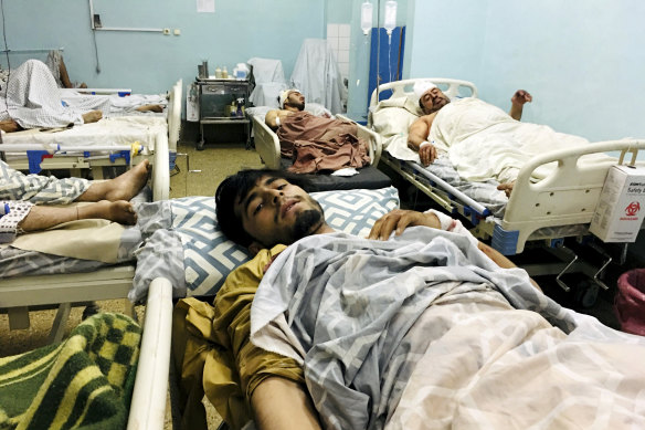 Wounded Afghans wait in hospital after two deadly explosions outside the airport in Kabul, Afghanistan.