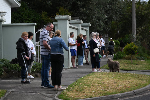 The crowd watches on for the auction at 20 Gareth Avenue.