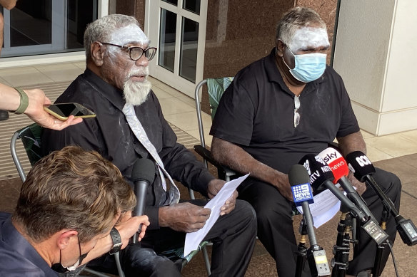 Community representatives Ned Jampijinpa Hargraves (left) and Lindsay Japangardi Williams speaking to the media pack outside the Darwin Supreme Court on the first day of the trial. 