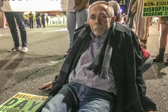 Brisbane man Frank Moeller glued himself to Grey Street, South Brisbane.