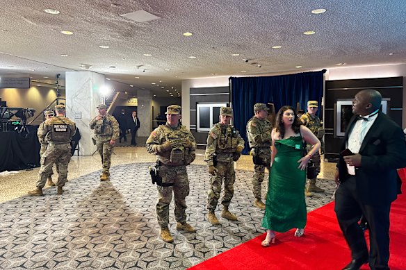 National Guard members escort guests out of the ballroom.