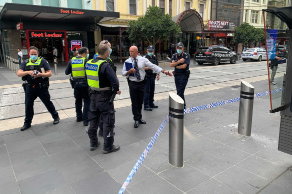 Police inspect broken glass and a damaged bollard in Bourke Street Mall, where a driver has caused chaos, causing pedestrians to jump out of the way, according to witnesses. 