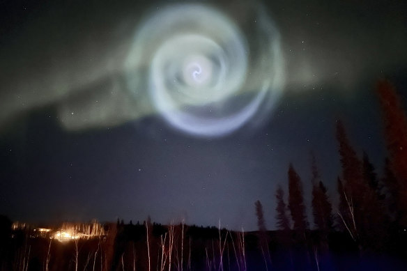 In this photo provided by Christopher Hayden, a blue spiral resembling a galaxy appears amid the aurora for a few minutes in the Alaska skies near Fairbanks.