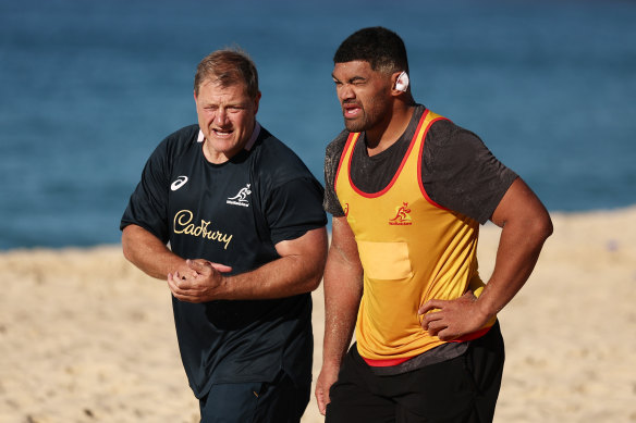 Jordan Uelese talking with scrum coach Neal Hatley on Coogee Beach.