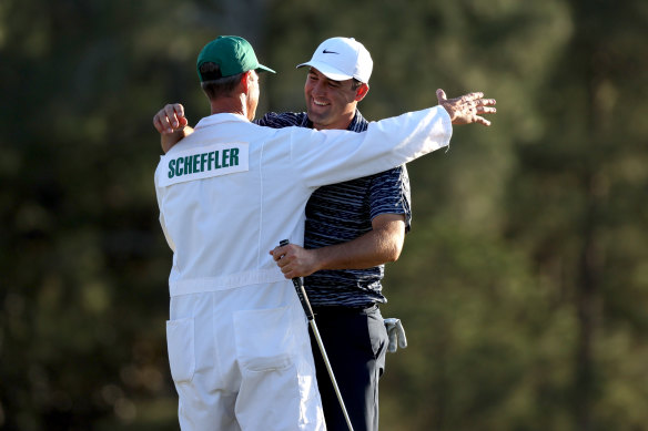 Scottie Scheffler and his caddie celebrate winning The Masters.