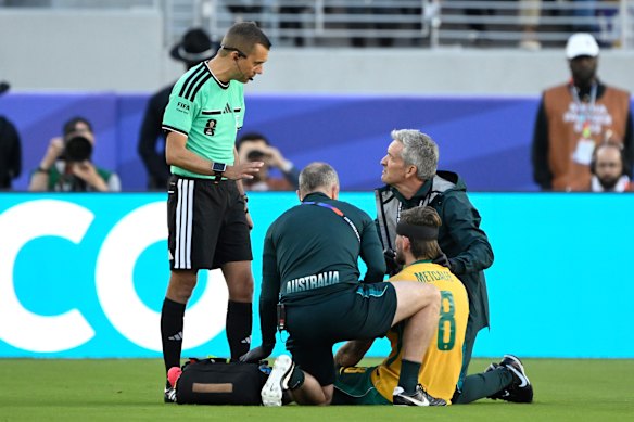 Connor Metcalfe receives medical assistance.