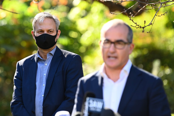 Victoria’s Chief Health Officer Professor Brett Sutton looks on as acting Premier James Merlino speaks to the media on Monday.