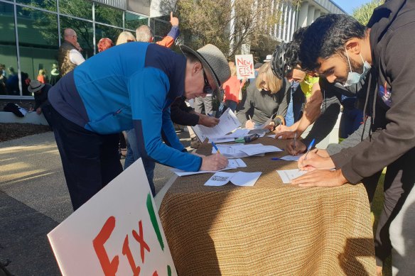 Residents filling out complaint forms.