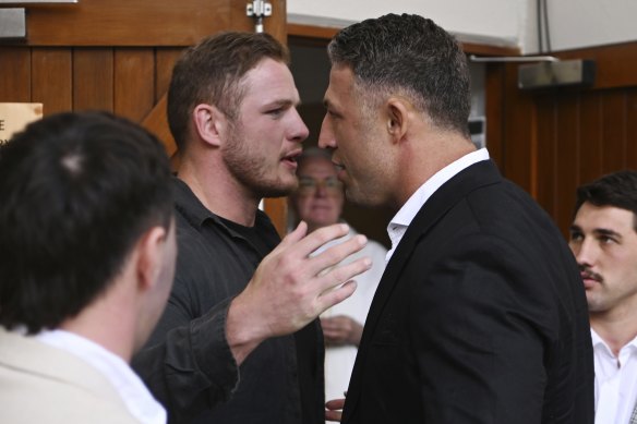 Brothers George and Sam Burgess pay their respects to John Sattler.