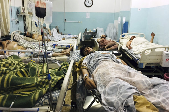 Afghans who were injured in the explosions outside the Kabul airport lie in hospital.