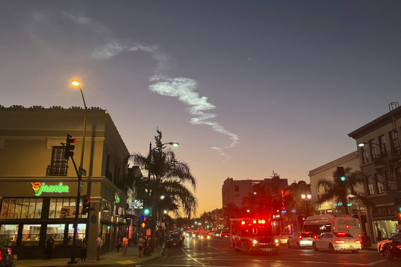 The contrail of a SpaceX Falcon 9 rocket is seen in the sky, from Pasadena, after launching from Vandenberg Space Force Base, California, carrying 53 Starlink satellites into orbit.