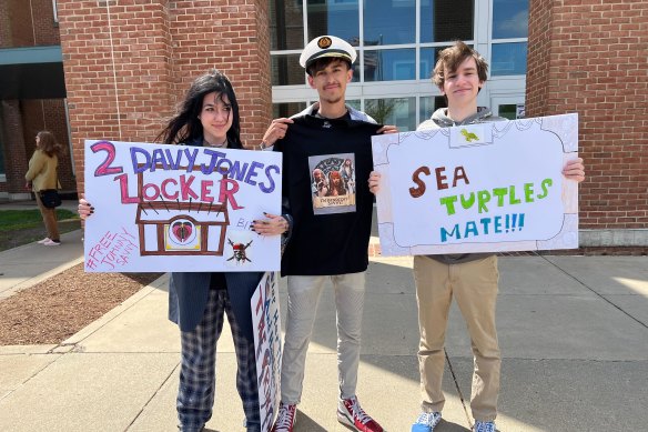 Pirates of the Caribbean fans Hannah Yeahgley, Ethan Diddlemeyer and Nick Lusby outside the Depp’s defamation trial with signs they made to support the actor.
