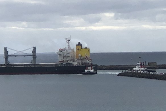 The tugs push and pull at the Panama-registered carrier, carrying 45,000 tonnes of wheat bound for Singapore.