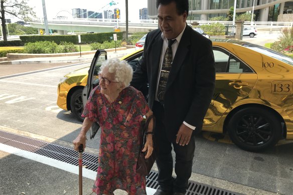 Ipswich's 107-year-old golden girl Liz Jordan, who arrived in a gold cab at the special Christmas lunch for Queensland's 100 Club members at Parliament House, with cab driver Napalu Mate.