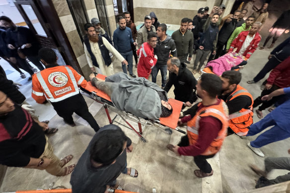 Injured Palestinians including children and women are brought to the Al Nasser Hospital following airstrikes in Khan Younis on Tuesday.