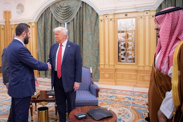 Sharaa shakes hands with Trump in Riyadh, Saudi Arabia, in May.