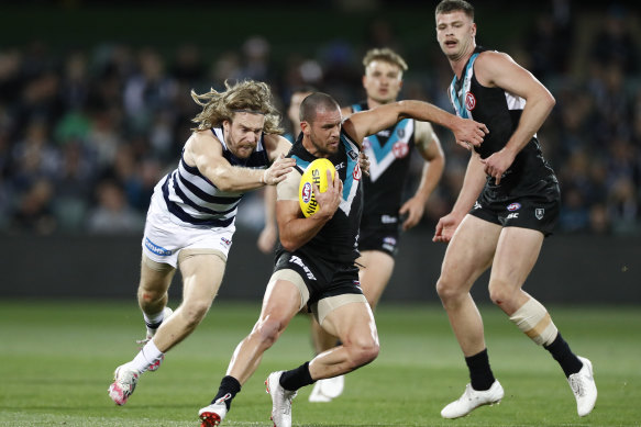 Travis Boak is chased by Tom Guthrie on Thursday night.