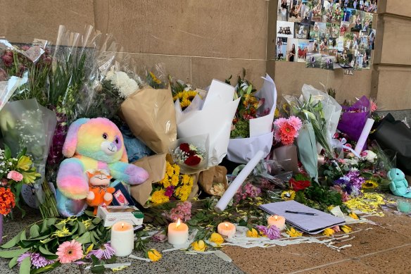 People lay flowers for Tia Cameron, who was killed in a bus in Brisbane’s CBD crash on Friday.