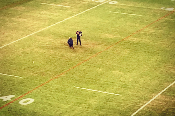Roosters official Chris James inspects the Bankwest surface long after Friday night's win.