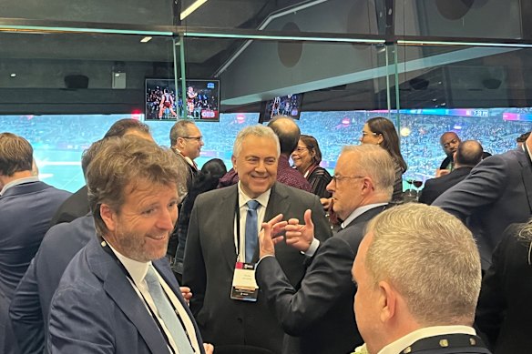 Albanese talks with Joe Hockey at the big match.