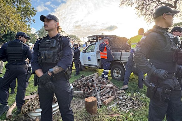 Council unloading a utility full of wood, dubbed by protesters as cultural wood. The wood was returned to protesters.