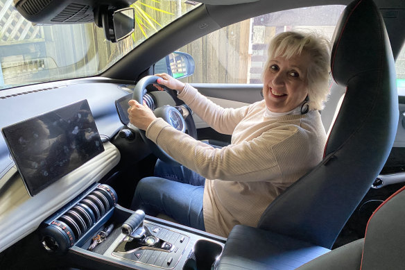 Jane Caro behind the wheel of her new electric vehicle.