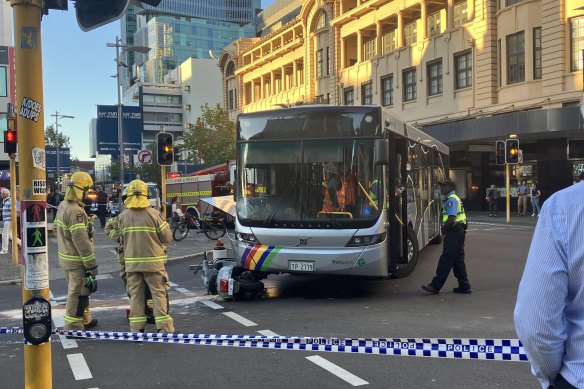 A moped has collided with a bus. 