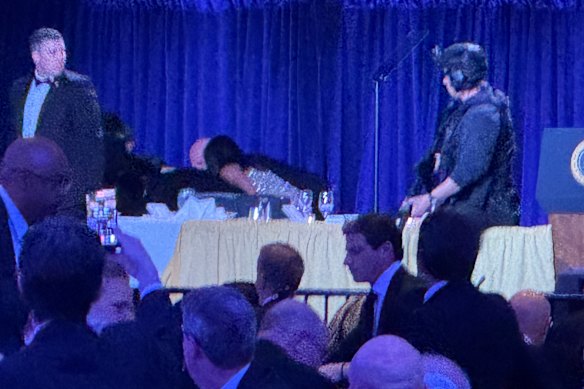 Secret Service agents respond after loud noises were heard at the White House Correspondents’ Dinner at the Washington Hilton Hotel.