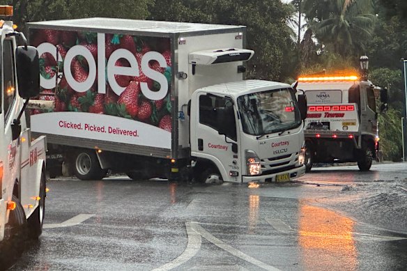 A Coles truck is stuck in a hole that has formed outside St Mary’s Cathedral in the Sydney CBD.
