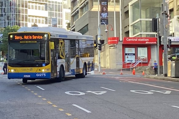 Police forensic crash unit experts photograph a Brisbane City Council bus as it travels from Ann Street into Edward Street as aprt of the investigation into the death of 18-year-old Tia Cameron on March 8.