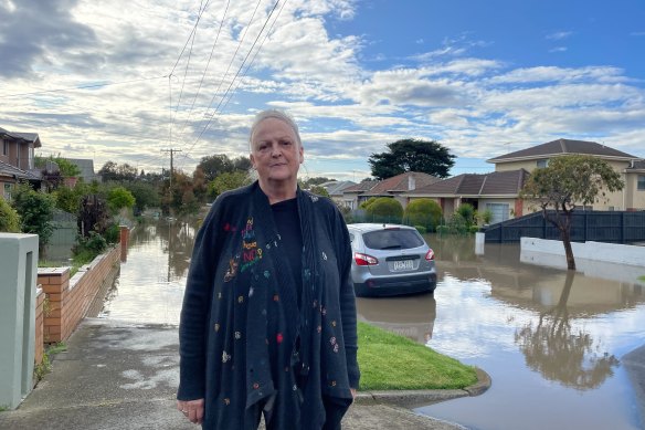 Jane Clifton, a well-known actor who lives on Duffy Street, watches floodwaters in Maribyrnong