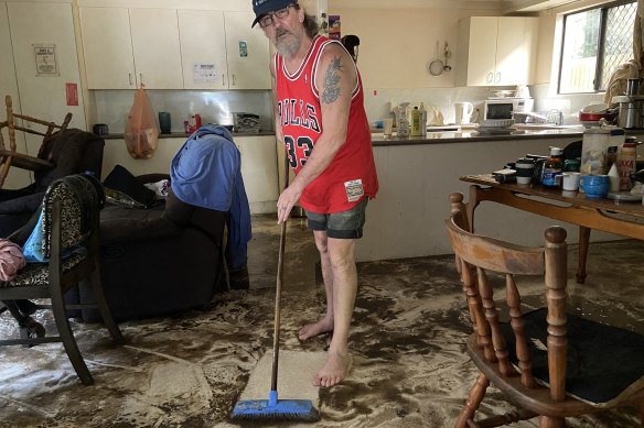 West End resident Mark Wheelhouse starts to mop his flood-damaged home. “It’s pretty tough really. I don’t really know where to start to clean up, except right at the beginning,” he said.