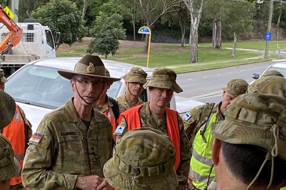 The Chief of the Australian Defence Force, General Angus Campbell, privately encourages troops as they clean up St Lucia on Saturday. 