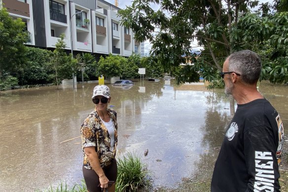 Jason and Rebecca Petzke assess floodwater at West End in 2022, where many newer developments were inundated.