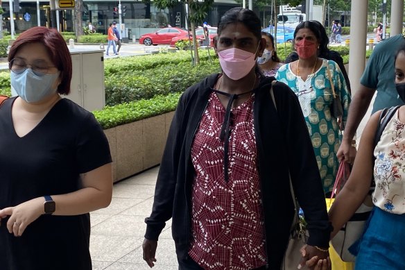 Panchalai Supermaniam, the mother of Nagaenthran Dharmalingam, arrives at court in Singapore with family members and supporters on Tuesday.