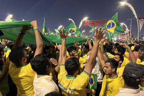 A group of Brazilian fans sing and dance along Doha’s Corniche.