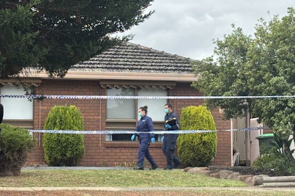 Forensic officers inspect one of the houses.