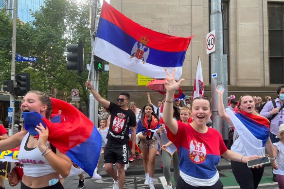 Serbian fans celebrate the news that Novak Djokovic had his visa cancellation overturned and was being released from detention.