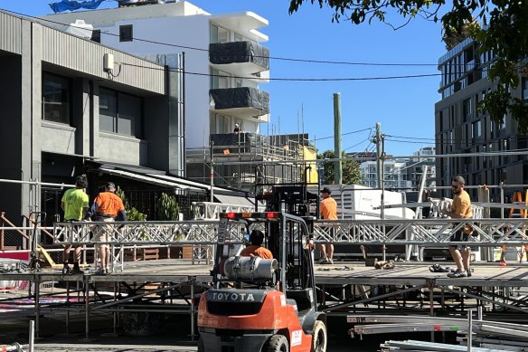 Workers erect a stage on Florence Street.