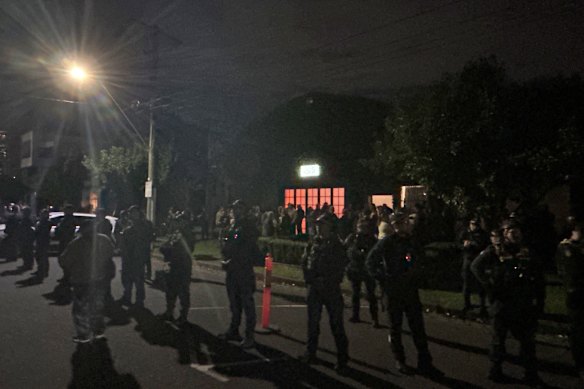 Police and protesters outside the event on Friday night.