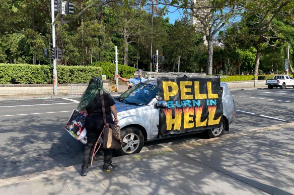 An anti-Pell protest car drives through the streets of Sydney.