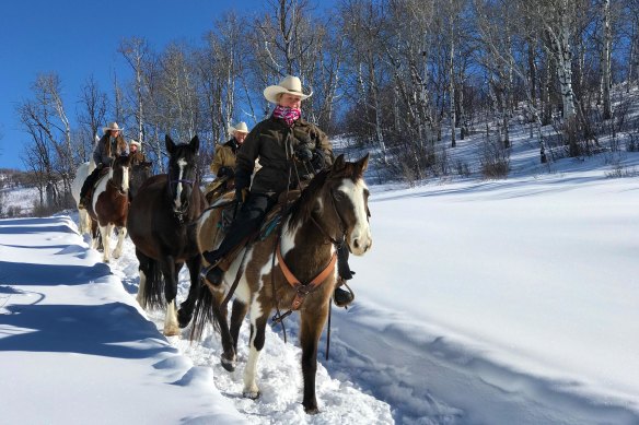 Trail riding through the snow with Del’s Triangle 3 Ranch.