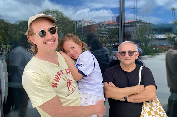 Daniel Gezowski, his daughter, and father-in-law Sam Isernia have been waiting in line for more than an hour to enter the new Sydney Fish Market.