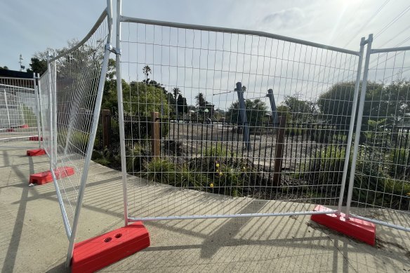 A gap forced open between sections of the temporary fencing.