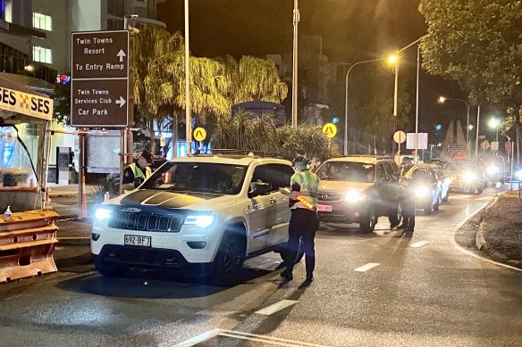 Some of the first people crossing the Queensland border, which opened earlier than 1am.