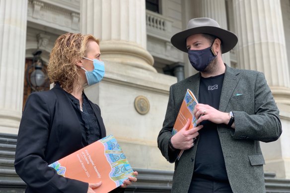 Minister for Aboriginal Affairs Gabrielle Williams receives the First Peoples’ Assembly annual report from Assembly Co-Chair Marcus Stewart on Thursday.
