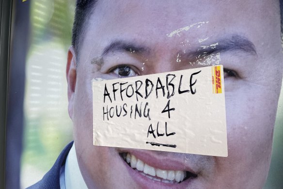 A sticker on a Brisbane real estate agent’s sign delivers a silent protest over the cost of housing.