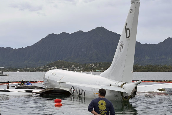 The US Navy aircraft is lifted to the surface by inflatable bags.